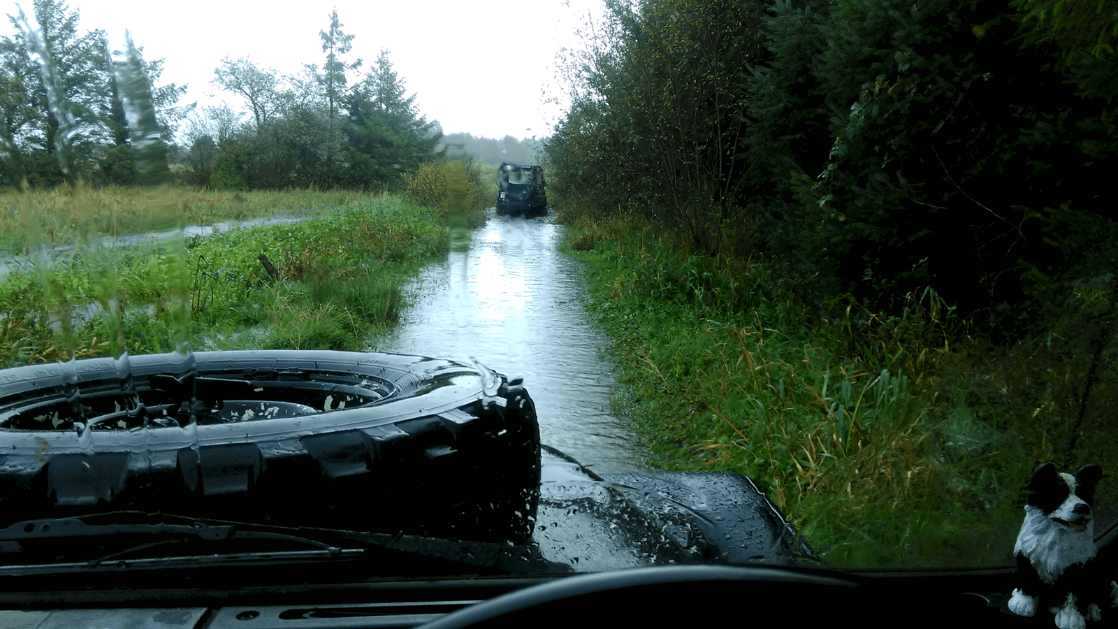 Land Rover driving in flooded lane